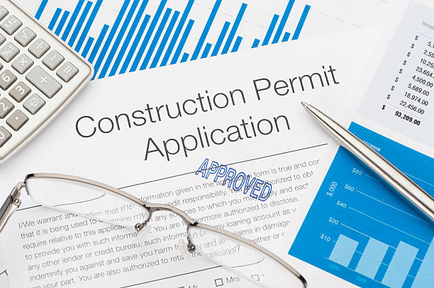 Approved Construction Permit Application Approved Construction Permit Application with pen and calculator  Licensing and Permits stock pictures, royalty-free photos & images