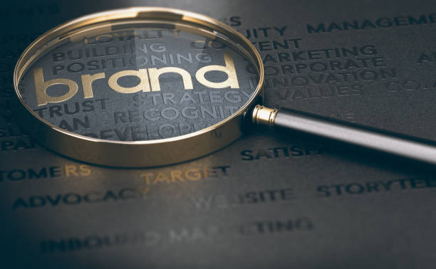 Brand management, Branding or rebranding concept. Brand marketing and management, branding or rebranding concept. 3d illustration of a magnifying glass over golden and black words.  Business Branding stock pictures, royalty-free photos & images