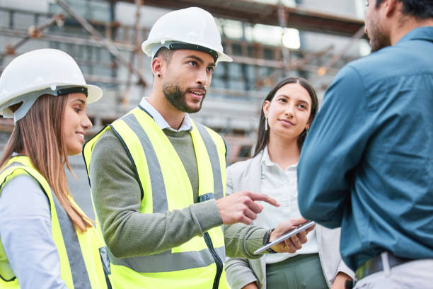 Shot of a team of architects having a meeting outside Do the hard jobs first Construction Business stock pictures, royalty-free photos & images