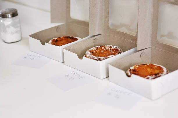 You can't start a party without it! Cropped shot of freshly baked cakes in takeaway boxes BakingPackaging and Labeling stock pictures, royalty-free photos & images