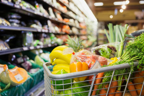 Close up of full shopping cart in grocery store  Groceries stock pictures, royalty-free photos & images