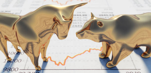 Bull and Bear on financial Newspaper Close up of golden Bull and Bear standing on a Stock Market Newspaper Gold Banking  stock pictures, royalty-free photos & images