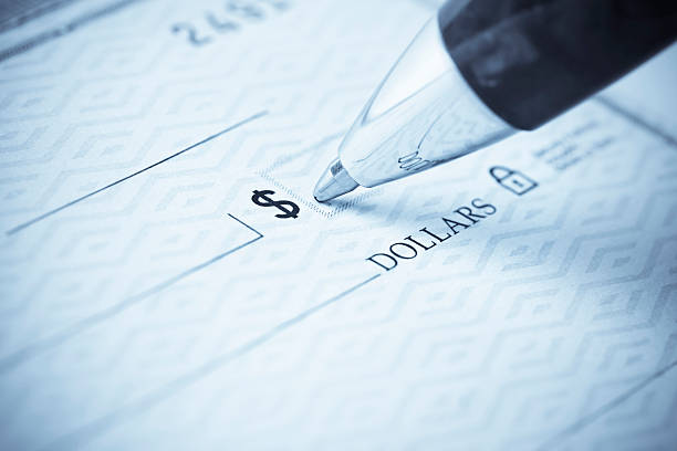 Pen being used to write a check Writing a check.  Please visit my lightbox for more similar photos writing Cheque  stock pictures, royalty-free photos & images