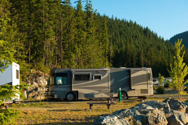 RV camp out in the great outdoors Recreational vehicles or motor homes parked in a wooded area. Mobile Home Insurance stock pictures, royalty-free photos & images