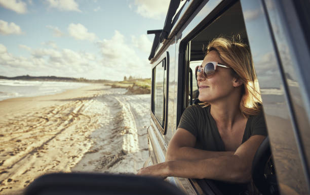 This is my kind of happy place! Cropped shot of a woman out on a road trip Travelling to Australia  stock pictures, royalty-free photos & images