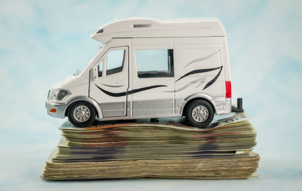 toy car with  pile of money  UK pounds banknotes toy car with  pile of money  UK pounds banknotes Mobile Home Insurance stock pictures, royalty-free photos & images