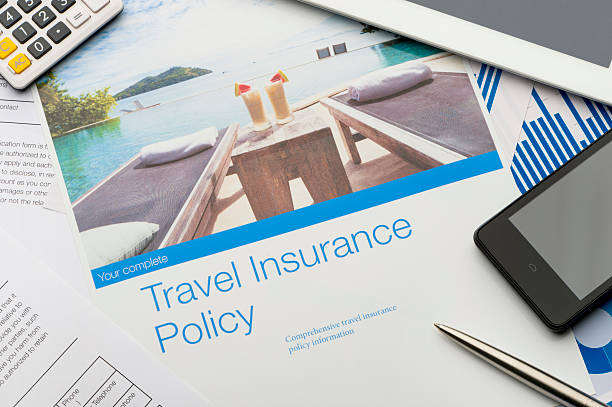 Travel insurance policy document with paperwork and technology. Travel insurance policy document with paperwork and technology. There is an image of a tourist resort with cocktails and a swimming pool which adds to the peace of mind concept. There is also a mobile phone, digital tablet and calculator. Image featured on the brochure is in my portfolio fine # 20943516 travel insurance stock pictures, royalty-free photos & images